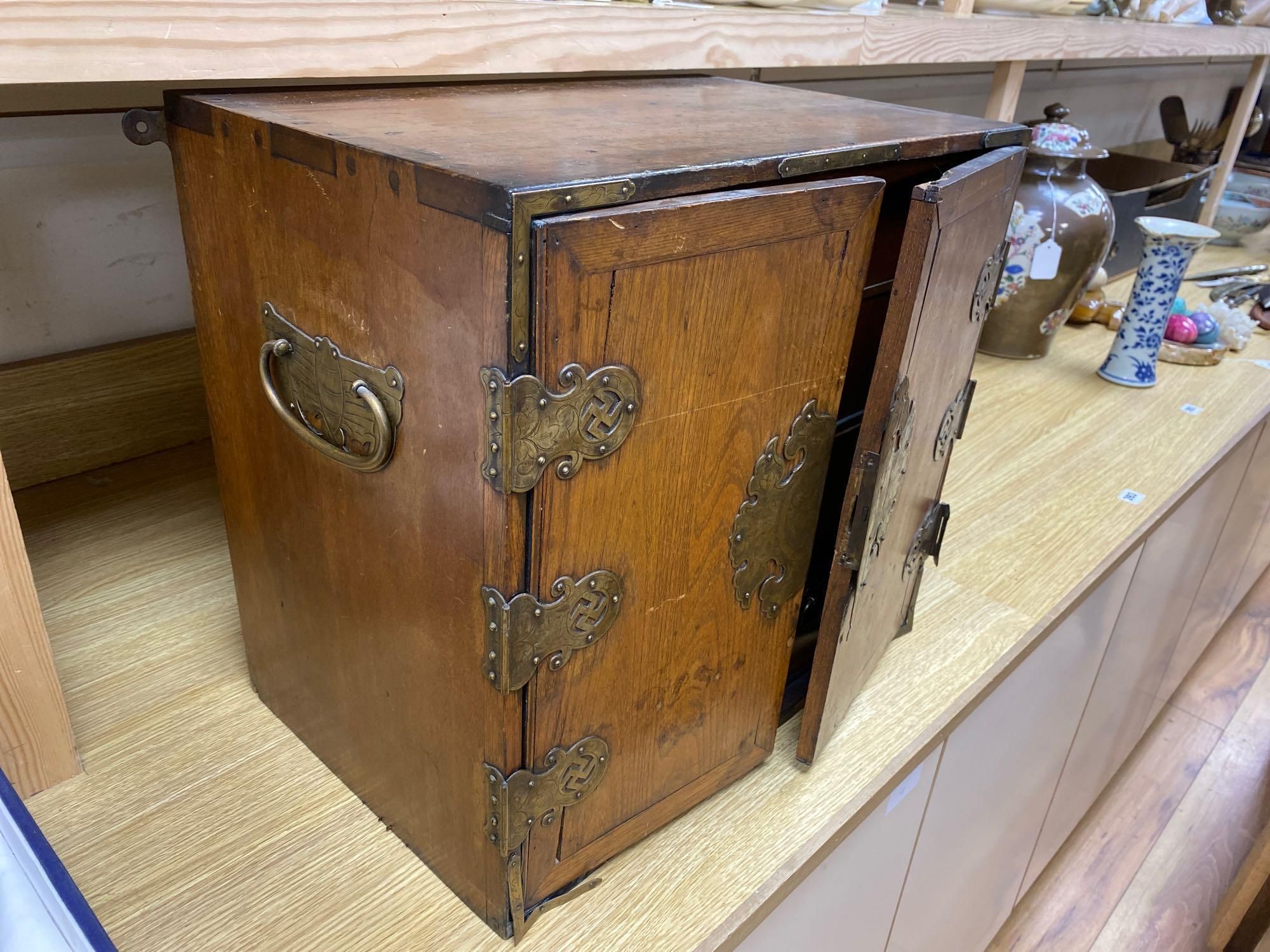 A Korean elm brass mounted table top cabinet